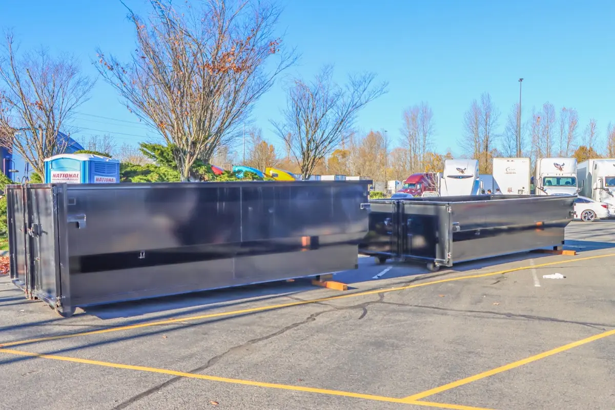 Professional dumpster rental service with roll-off container on residential driveway in Lecanto